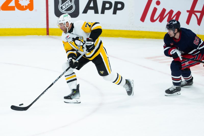 Feb 10, 2024; Winnipeg, Manitoba, CAN;  Pittsburgh Penguins forward Jeff Carter (77) skates away from Winnipeg Jets forward Sean Monahan (23) during the third period at Canada Life Centre. Mandatory Credit: Terrence Lee-USA TODAY Sports