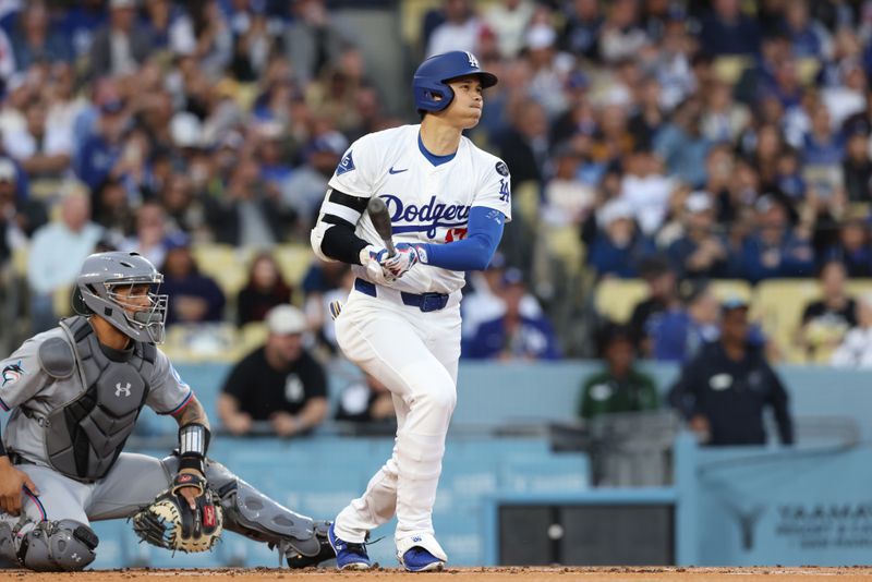 Apr 28, 2025; Los Angeles, California, USA; Los Angeles Dodgers two-way player Shohei Ohtani (17) hits a single in the first inning against the Miami Marlins during the first inning at Dodger Stadium. Mandatory Credit: Jason Parkhurst-Imagn Images