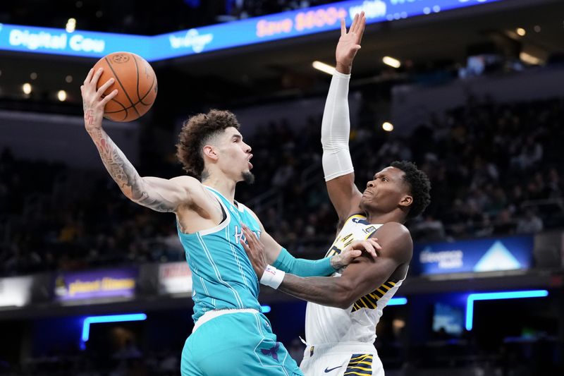 INDIANAPOLIS, INDIANA - OCTOBER 17: LaMelo Ball #1 of the Charlotte Hornets attempts a shot while being guarded by Bennedict Mathurin #00 of the Indiana Pacers in the first quarter during a preseason game at Gainbridge Fieldhouse on October 17, 2024 in Indianapolis, Indiana. NOTE TO USER: User expressly acknowledges and agrees that, by downloading and or using this photograph, User is consenting to the terms and conditions of the Getty Images License Agreement. (Photo by Dylan Buell/Getty Images)