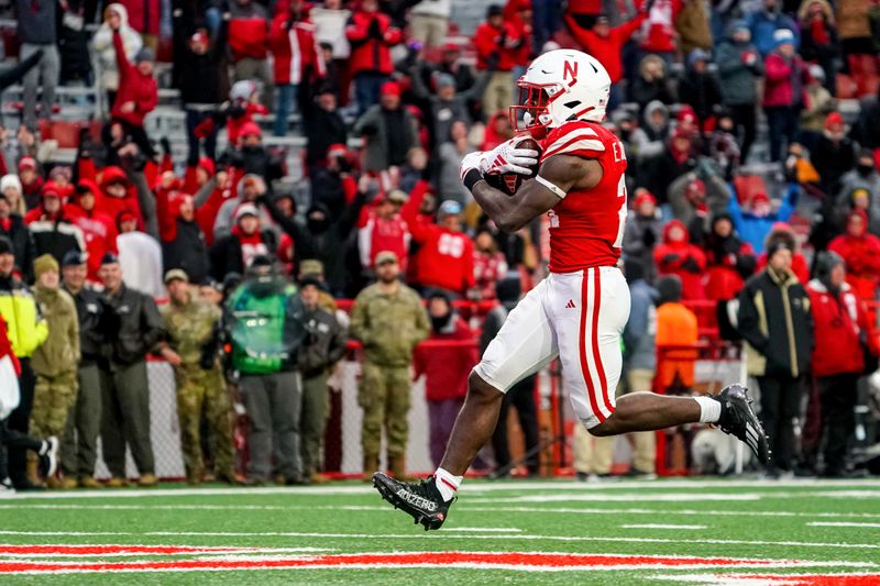 Oct 28, 2023; Lincoln, Nebraska, USA; Nebraska Cornhuskers running back Emmett Johnson (21) runs for a touchdown against the Purdue Boilermakers during the fourth quarter at Memorial Stadium. Mandatory Credit: Dylan Widger-USA TODAY Sports