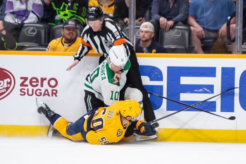 Feb 15, 2024; Nashville, Tennessee, USA; Nashville Predators defenseman Roman Josi (59) and Dallas Stars center Ty Dellandrea (10) take down referee Chris Lee (28) during the second period at Bridgestone Arena. Mandatory Credit: Steve Roberts-USA TODAY Sports