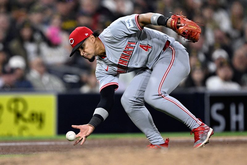 Apr 29, 2024; San Diego, California, USA; Cincinnati Reds third baseman Santiago Espinal (4) fields a ground ball bare-handed during the seventh inning against the San Diego Padres at Petco Park. Mandatory Credit: Orlando Ramirez-USA TODAY Sports