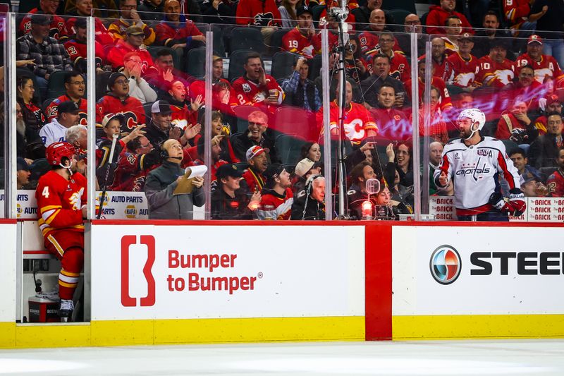 Jan 28, 2025; Calgary, Alberta, CAN; Calgary Flames defenseman Rasmus Andersson (4) and Washington Capitals right wing Tom Wilson (43) exchanges words during the third period at Scotiabank Saddledome. Mandatory Credit: Sergei Belski-Imagn Images