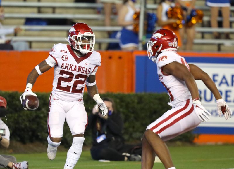 Nov 14, 2020; Gainesville, FL, USA; Arkansas Razorbacks running back Trelon Smith (22) celebrates with a teammate in the end zone after scoring a touchdown on a long run during a football game against Florida at Ben Hill Griffin Stadium.  Mandatory Credit: Brad McClenny-USA TODAY NETWORK