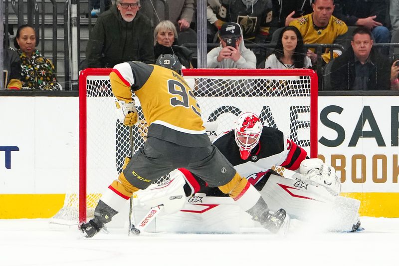 Dec 17, 2025; Las Vegas, Nevada, USA; New Jersey Devils goaltender Jake Allen (34) makes a save against Vegas Golden Knights right wing Mitch Marner (93) during a shoot out to give the Devils a 2-1 victory at T-Mobile Arena. Mandatory Credit: Stephen R. Sylvanie-Imagn Images