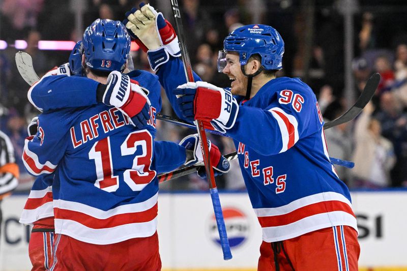 Apr 13, 2024; New York, New York, USA;  New York Rangers left wing Alexis Lafrenière (13) and New York Rangers center Jack Roslovic (96) celebrate with New York Rangers center Vincent Trocheck (16) after scoring the game clinching goal against the New York Islanders after shoot outs at Madison Square Garden. Mandatory Credit: Dennis Schneidler-USA TODAY Sports