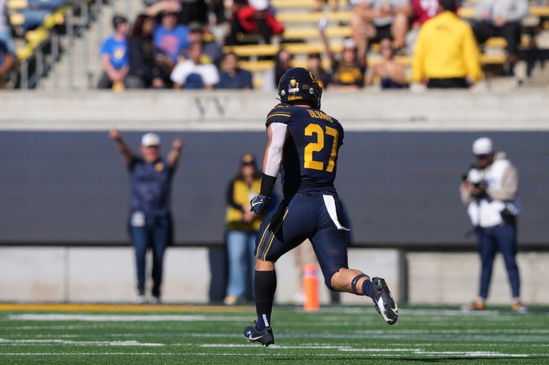 Nov 11, 2023; Berkeley, California, USA; California Golden Bears linebacker Cade Uluave (27) returns a fumble for a touchdown against the Washington State Cougars during the first quarter at California Memorial Stadium. Mandatory Credit: Darren Yamashita-USA TODAY Sports 