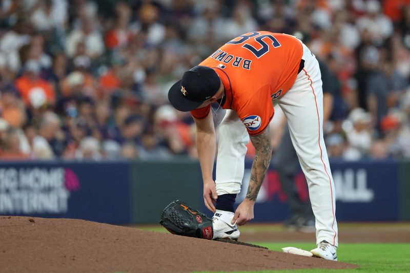 Oct 2, 2024; Houston, Texas, USA; Houston Astros pitcher Hunter Brown (58) adjusts his shoes before throwing against the Detroit Tigers during the second inning of game two of the Wildcard round for the 2024 MLB Playoffs at Minute Maid Park. Mandatory Credit: Thomas Shea-Imagn Images