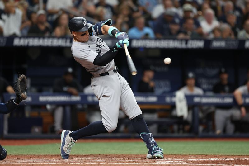 Jul 10, 2024; St. Petersburg, Florida, USA; New York Yankees designated hitter Aaron Judge (99) singles against the Tampa Bay Rays in the sixth inning at Tropicana Field. Mandatory Credit: Nathan Ray Seebeck-USA TODAY Sports