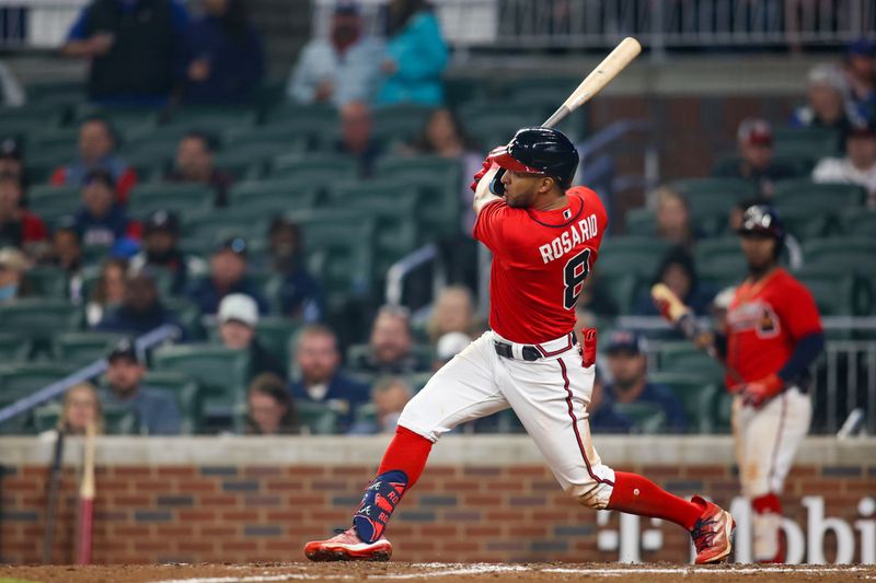 May 5, 2023; Atlanta, Georgia, USA; Atlanta Braves left fielder Eddie Rosario (8) hits a single against the Baltimore Orioles in the eighth inning at Truist Park. Mandatory Credit: Brett Davis-USA TODAY Sports