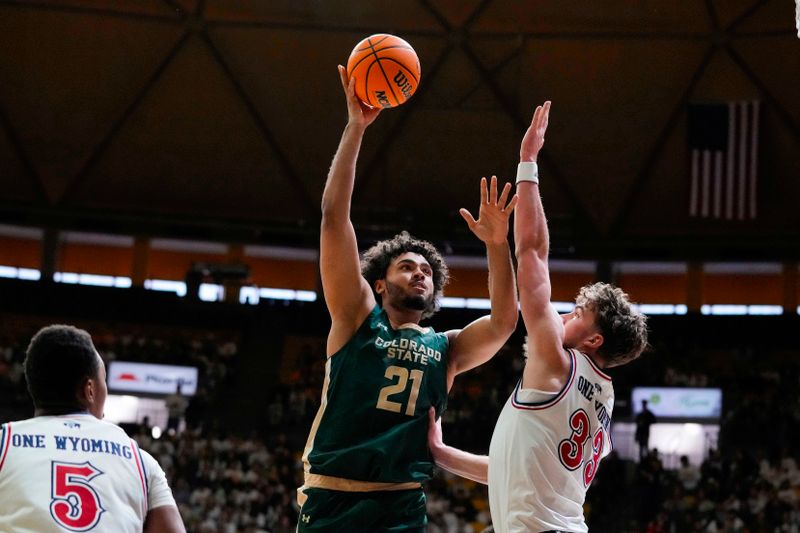 Jan 27, 2024; Laramie, Wyoming, USA; Colorado State Rams guard Rashaan Mbemba (21) shoots over Wyoming Cowboys forward Mason Walters (33) during the first half at Arena-Auditorium. Mandatory Credit: Troy Babbitt-USA TODAY Sports