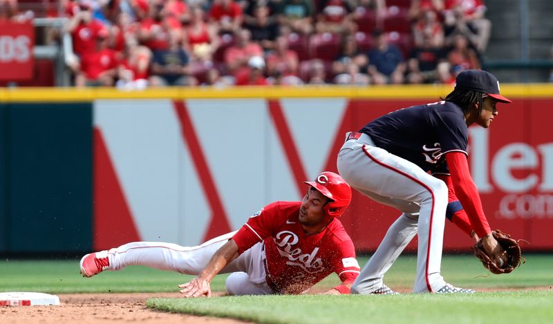 Aug 5, 2023; Cincinnati, Ohio, USA; Cincinnati Reds catcher Luke Maile (22) is safe at second against Washington Nationals shortstop CJ Abrams (5) during the sixth inning at Great American Ball Park. Mandatory Credit: David Kohl-USA TODAY Sports