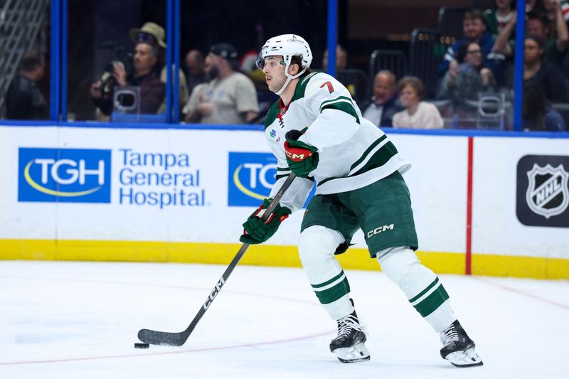Mar 24, 2026; Tampa, Florida, USA; Minnesota Wild defenseman Brock Faber (7) controls the puck against the Tampa Bay Lightning in the first period at Benchmark International Arena. Mandatory Credit: Nathan Ray Seebeck-Imagn Images