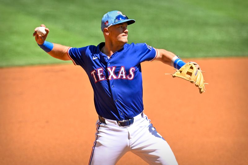 Mar 26, 2024; Arlington, Texas, USA; Texas Rangers third baseman Josh Jung (6) throws to third base during the first inning against the Boston Red Sox at Globe Life Field. Mandatory Credit: Jerome Miron-USA TODAY Sports