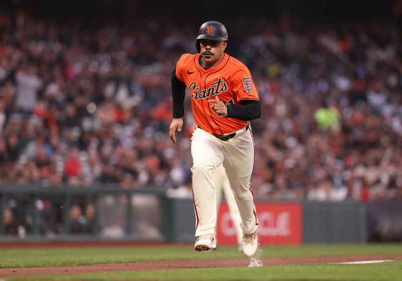 May 2, 2025; San Francisco, California, USA; San Francisco Giants first baseman LaMonte Wade Jr. (31) scores on a wild pitch by the Colorado Rockies during the second inning at Oracle Park. Mandatory Credit: Kelley L Cox-Imagn Images