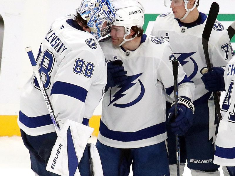 Nov 19, 2024; Pittsburgh, Pennsylvania, USA; Tampa Bay Lightning goaltender Andrei Vasilevskiy (88), center Brayden Point (21), and defenseman Emil Lilleberg (78) celebrate after defeating the Pittsburgh Penguins in overtime at PPG Paints Arena. Mandatory Credit: Charles LeClaire-Imagn Images