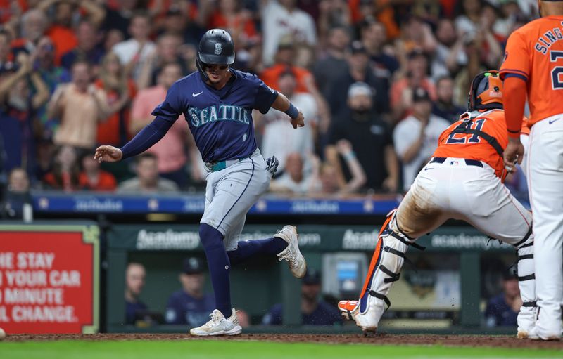 May 3, 2024; Houston, Texas, USA; Seattle Mariners third baseman Josh Rojas (4) is caught in a run-down during the eighth inning against the Houston Astros at Minute Maid Park. Mandatory Credit: Troy Taormina-USA TODAY Sports