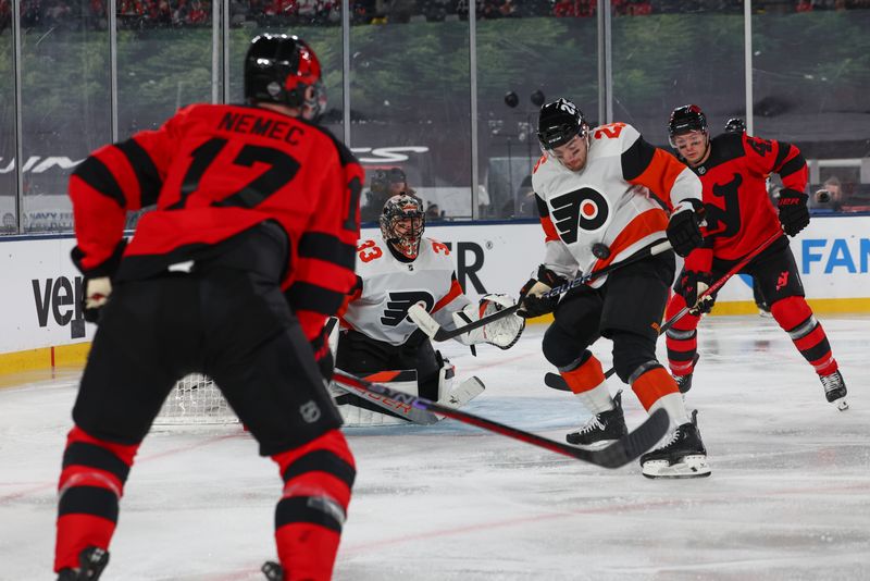 Feb 17, 2024; East Rutherford, New Jersey, USA; Philadelphia Flyers defenseman Sean Walker (26) blocks a shot against the New Jersey Devils during the second period in a Stadium Series ice hockey game at MetLife Stadium. Mandatory Credit: Ed Mulholland-USA TODAY Sports