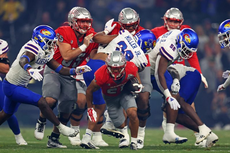 Dec 26, 2023; Phoenix, AZ, USA; UNLV Rebels wide receiver Jacob De Jesus (21) runs the ball during the first quarter of the Guaranteed Rate Bowl against the Kansas Jayhawks at Chase Field. Mandatory Credit: Mark J. Rebilas-USA TODAY Sports