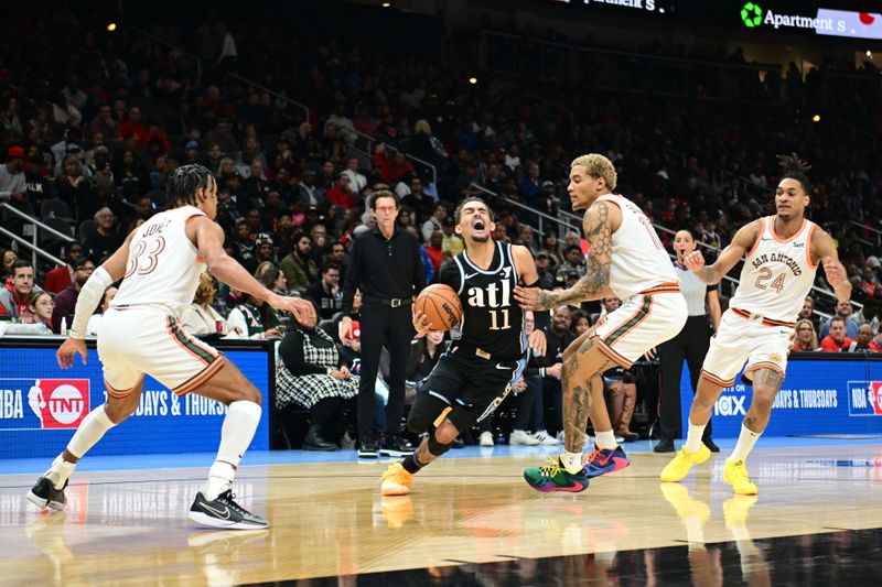 ATLANTA, GA - JANUARY 15: Trae Young #11 of the Atlanta Hawks drives to the basket during the game against the San Antonio Spurs on January 15, 2024 at State Farm Arena in Atlanta, Georgia.  NOTE TO USER: User expressly acknowledges and agrees that, by downloading and/or using this Photograph, user is consenting to the terms and conditions of the Getty Images License Agreement. Mandatory Copyright Notice: Copyright 2024 NBAE (Photo by Adam Hagy/NBAE via Getty Images)