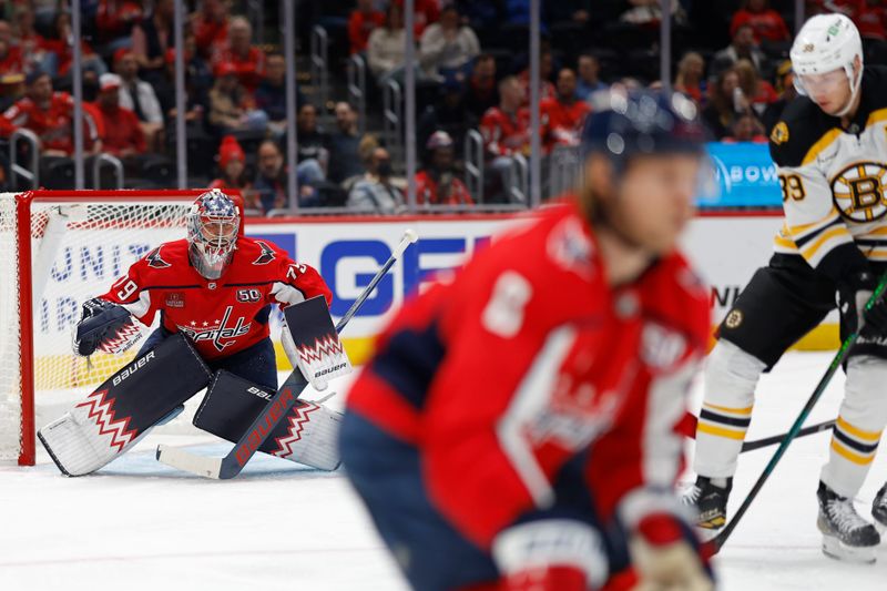 Oct 5, 2024; Washington, District of Columbia, USA; Washington Capitals goaltender Charlie Lindgren (79) prepares to make a save on Boston Bruins center Morgan Geekie (39) in the second period at Capital One Arena. Mandatory Credit: Geoff Burke-Imagn Images