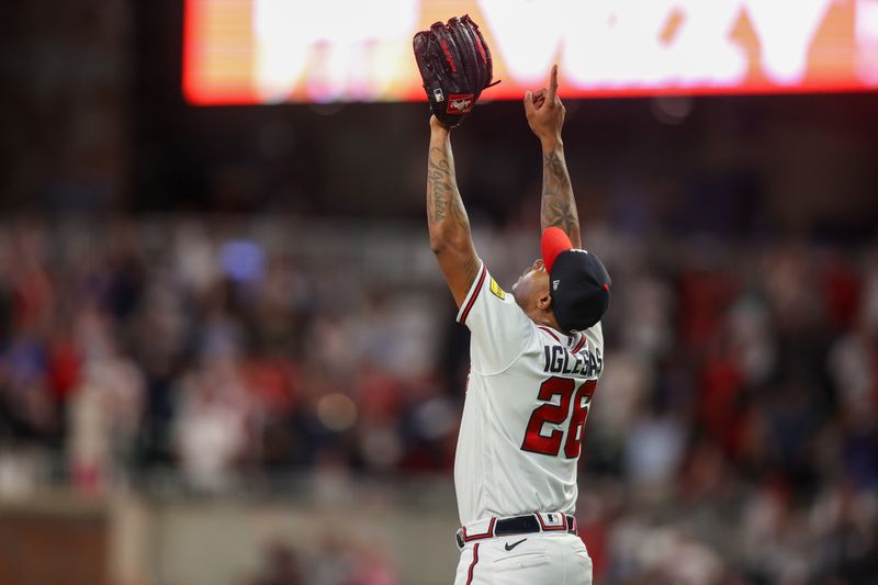 Aug 16, 2023; Atlanta, Georgia, USA; Atlanta Braves relief pitcher Raisel Iglesias (26) celebrates after a victory against the New York Yankees at Truist Park. Mandatory Credit: Brett Davis-USA TODAY Sports
