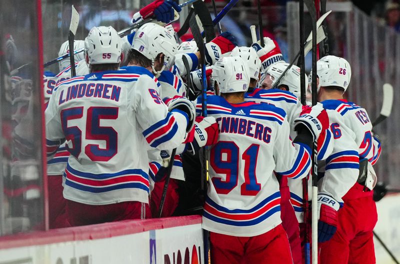 May 16, 2024; Raleigh, North Carolina, USA; New York Rangers players celebrate after New York Rangers center Barclay Goodrow (21) scores an empty net goal against the Carolina Hurricanes during the third period in game six of the second round of the 2024 Stanley Cup Playoffs at PNC Arena. Mandatory Credit: James Guillory-USA TODAY Sports