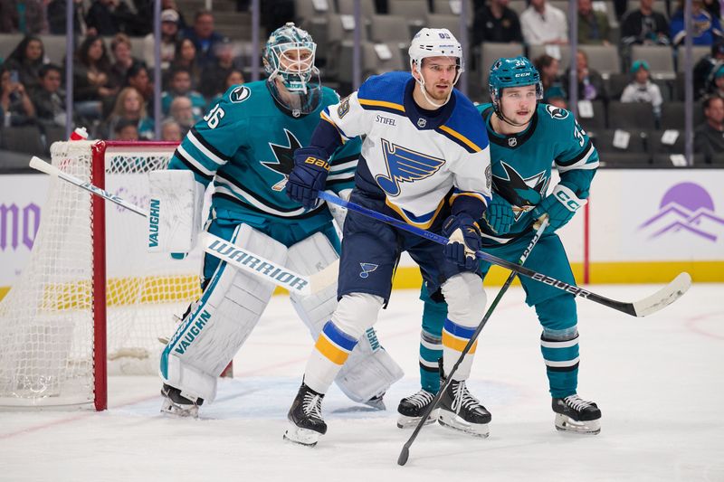 Nov 16, 2023; San Jose, California, USA; San Jose Sharks defenseman Calen Addison (33) and goaltender Kaapo Kahkonen (36) defend against St. Louis Blues left wing Pavel Buchnevich (89) in the slot during the first period at SAP Center at San Jose. Mandatory Credit: Robert Edwards-USA TODAY Sports