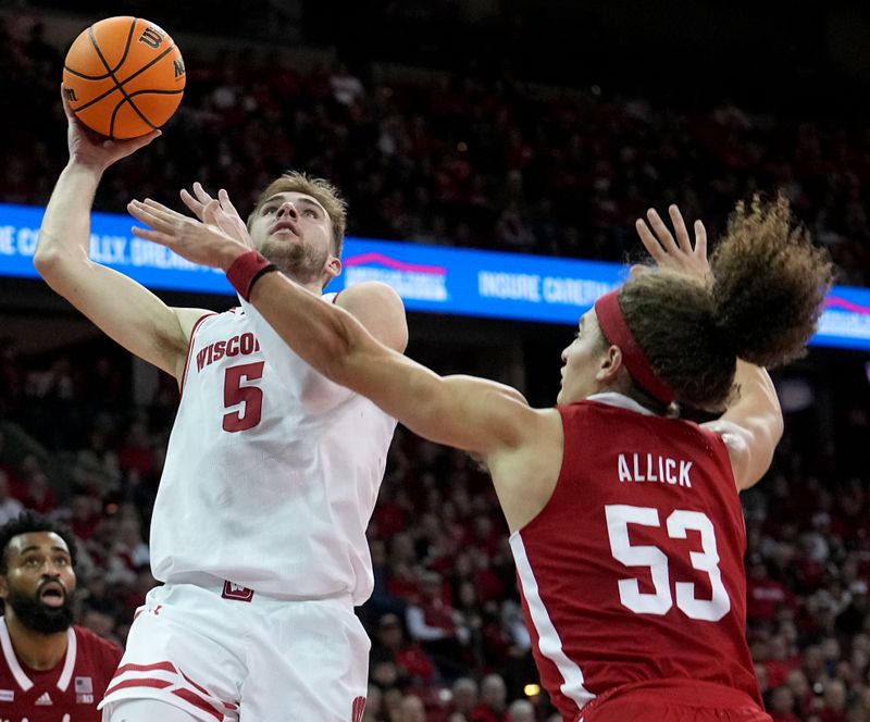 Jan 6, 2024; Madison, Wisconsin, USA; Wisconsin forward Tyler Wahl (5) scores on Nebraska forward Josiah Allick (53) during the second half  at Kohl Center. Mandatory Credit: Mark Hoffman-USA TODAY Sports