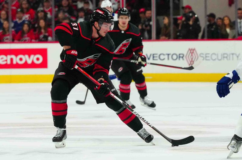 Nov 24, 2023; Raleigh, North Carolina, USA; Carolina Hurricanes right wing Andrei Svechnikov (37) skates with the puck against the Tampa Bay Lightning during the first period at PNC Arena. Mandatory Credit: James Guillory-USA TODAY Sports