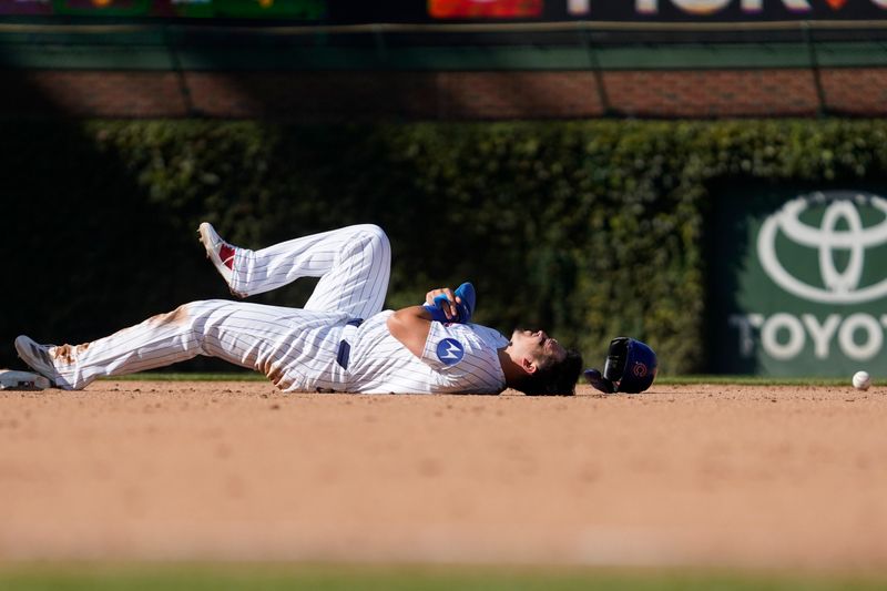 Sep 20, 2024; Chicago, Illinois, USA; Chicago Cubs outfielder Seiya Suzuki (27) steals second base and is hit by the ball against the Washington Nationals during the eighth inning at Wrigley Field. Mandatory Credit: David Banks-Imagn Images