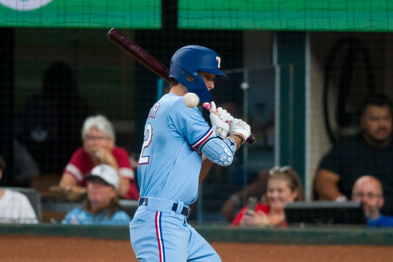 Sep 10, 2023; Arlington, Texas, USA; Texas Rangers left fielder Evan Carter (32) avoids getting hit by a pitch during the fifth inning against the Oakland Athletics at Globe Life Field. Mandatory Credit: Jerome Miron-USA TODAY Sports