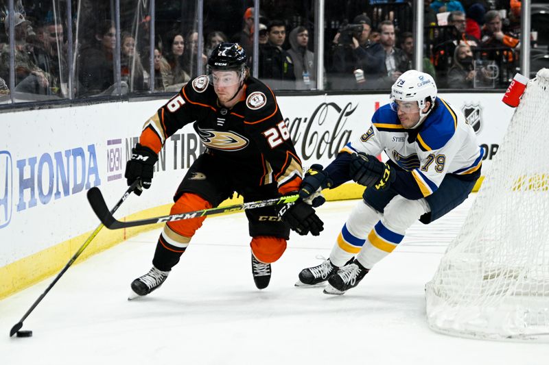 Mar 25, 2023; Anaheim, California, USA;Anaheim Ducks left wing Brock McGinn (26) moves the puck around the net while pressured by St. Louis Blues left wing Sammy Blais (79) during the second period at Honda Center. Mandatory Credit: Kelvin Kuo-USA TODAY Sports