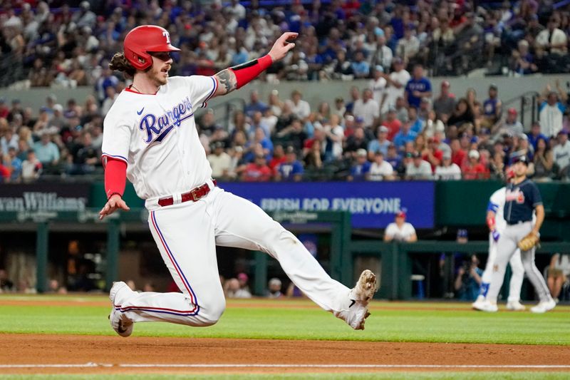 May 17, 2023; Arlington, Texas, USA; Texas Rangers catcher Jonah Heim (28) slide into third base during the fourth inning against the Atlanta Braves at Globe Life Field. Mandatory Credit: Raymond Carlin III-USA TODAY Sports