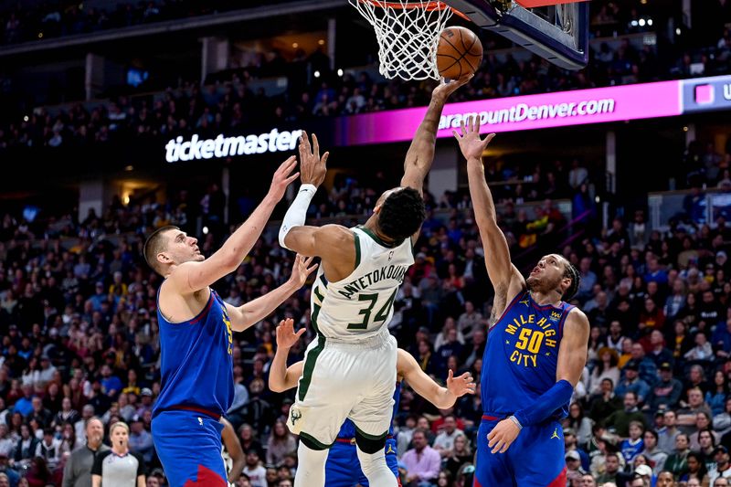 DENVER, CO - MARCH 25:  Giannis Antetokounmpo #34 of the Milwaukee Bucks is defended by Nikola Jokic #15 and Aaron Gordon #50 of the Denver Nuggets in the second half of a game at Ball Arena on March 25, 2023 in Denver, Colorado. NOTE TO USER: User expressly acknowledges and agrees that, by downloading and or using this photograph, User is consenting to the terms and conditions of the Getty Images License Agreement. (Photo by Dustin Bradford/Getty Images)