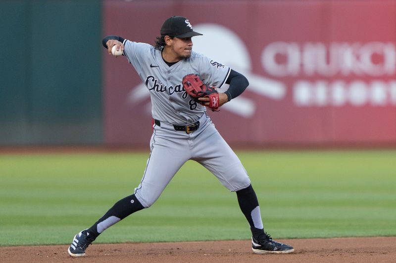 Aug 6, 2024; Oakland, California, USA;  Chicago White Sox second base Nicky Lopez (8) throws the ball during the fourth inning against the Oakland Athletics at Oakland-Alameda County Coliseum. Mandatory Credit: Stan Szeto-USA TODAY Sports