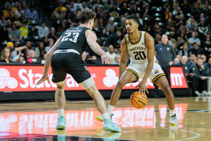 Mar 2, 2024; Wichita, Kansas, USA; Wichita State Shockers guard Harlond Beverly (20) brings the ball up court around Rice Owls guard Alem Huseinovic (23) during the first half at Charles Koch Arena. Mandatory Credit: William Purnell-USA TODAY Sports