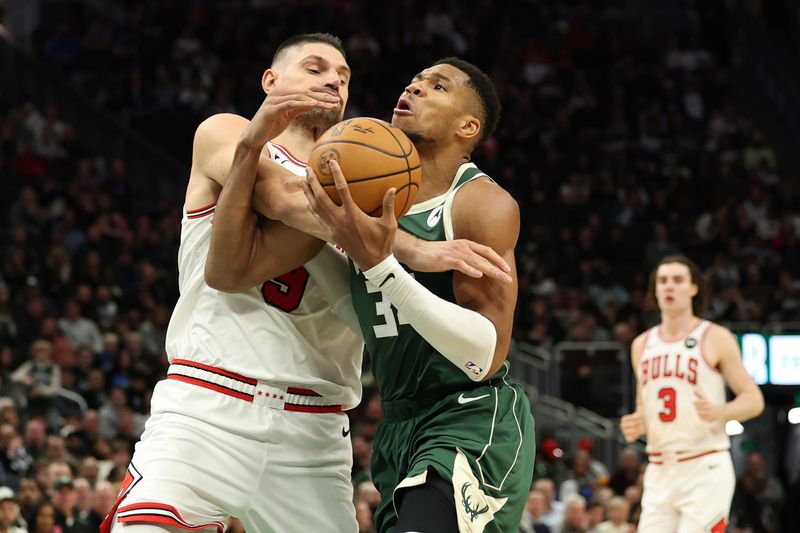 MILWAUKEE, WISCONSIN - NOVEMBER 20: Giannis Antetokounmpo #34 of the Milwaukee Bucks is fouled by Nikola Vucevic #9 of the Chicago Bulls during the second half of a game at Fiserv Forum on November 20, 2024 in Milwaukee, Wisconsin. NOTE TO USER: User expressly acknowledges and agrees that, by downloading and or using this photograph, User is consenting to the terms and conditions of the Getty Images License Agreement. (Photo by Stacy Revere/Getty Images)