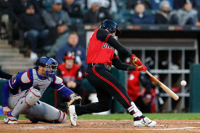 May 23, 2025; Chicago, Illinois, USA; Chicago White Sox designated hitter Andrew Benintendi (23) hits an RBI-sacrifice fly against the Texas Rangers during the third inning at Rate Field. Mandatory Credit: Kamil Krzaczynski-Imagn Images