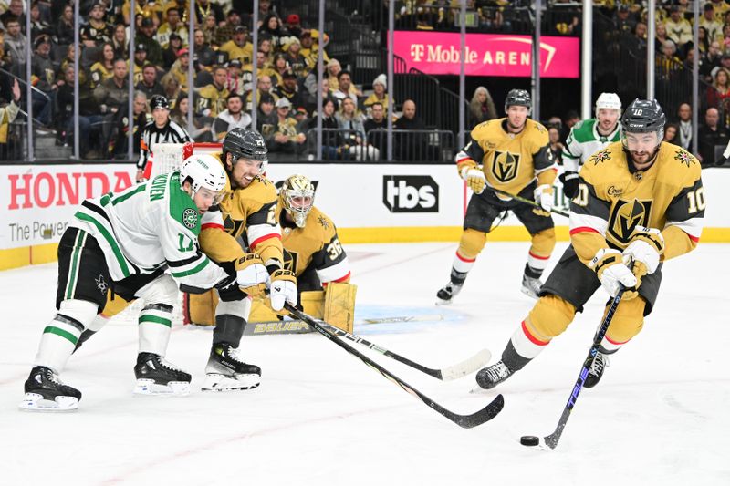 Apr 27, 2024; Las Vegas, Nevada, USA; Dallas Stars center Logan Stankoven (11) battles for the puck with Vegas Golden Knights defenseman Shea Theodore (27) and center Nicolas Roy (10) in overtime in game three of the first round of the 2024 Stanley Cup Playoffs at T-Mobile Arena. Mandatory Credit: Candice Ward-USA TODAY Sports