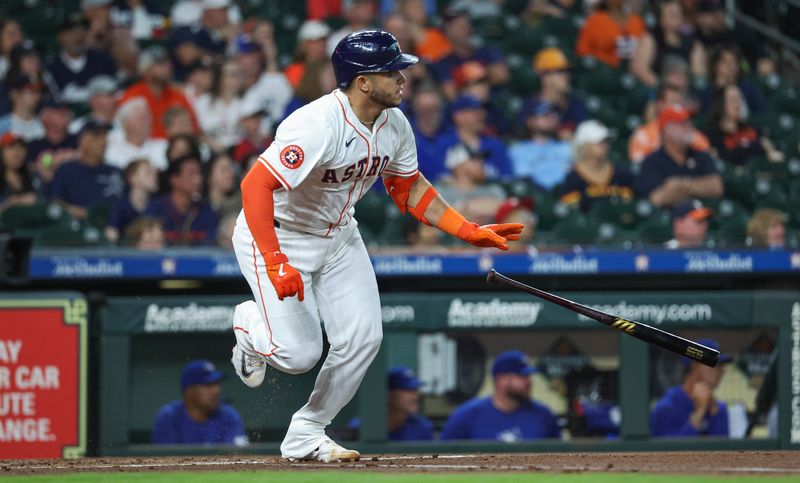 Apr 3, 2024; Houston, Texas, USA; Houston Astros catcher Yainer Diaz (21) hits a single during the first inning against the Toronto Blue Jays at Minute Maid Park. Mandatory Credit: Troy Taormina-USA TODAY Sports