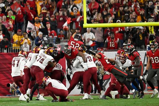 Washington Commanders place kicker Zane Gonzalez (47) kicks the game winning field goal against the Tampa Bay Buccaneers during the second half of an NFL wild-card playoff football game in Tampa, Fla., Sunday, Jan. 12, 2025. (AP Photo/Jason Behnken)