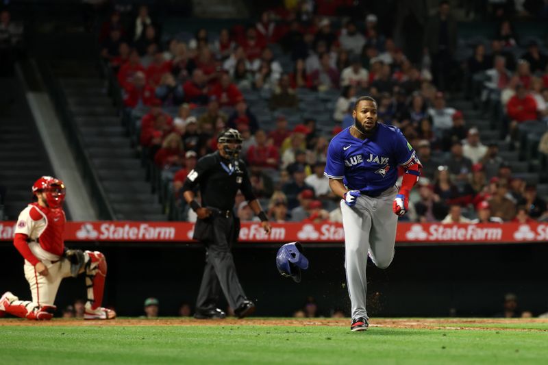 May 7, 2025; Anaheim, California, USA;  Toronto Blue Jays first baseman Vladimir Guerrero Jr. (27) hits a double during the sixth inning against the Los Angeles Angels at Angel Stadium. Mandatory Credit: Kiyoshi Mio-Imagn Images