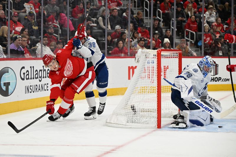 Nov 28, 2025; Detroit, Michigan, USA; Tampa Bay Lightning left wing Brandon Hagel (38) steers Detroit Red Wings defenseman Simon Edvinsson (77) away from the puck bedding the Lightning goal in the second period at Little Caesars Arena. Mandatory Credit: Lon Horwedel-Imagn Images