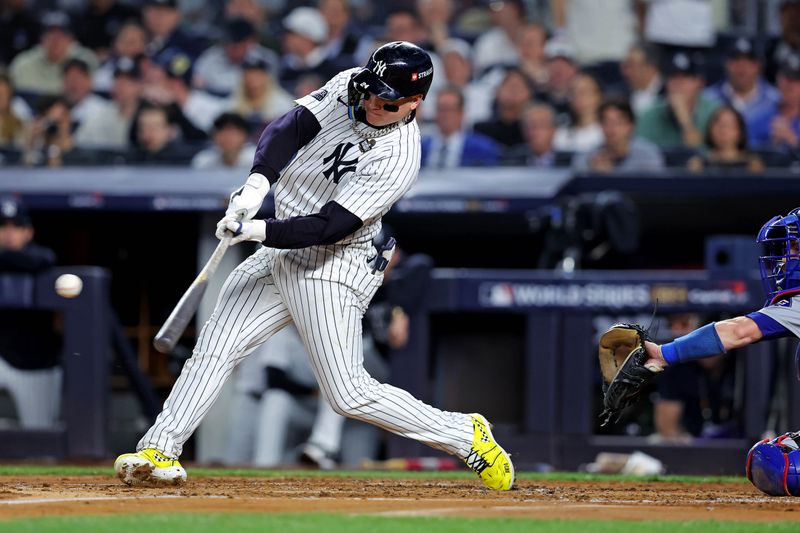 Oct 30, 2024; New York, New York, USA; New York Yankees outfielder Alex Verdugo (24) hits an RBI single during the second inning against the Los Angeles Dodgers in game four of the 2024 MLB World Series at Yankee Stadium. Mandatory Credit: Brad Penner-Imagn Images