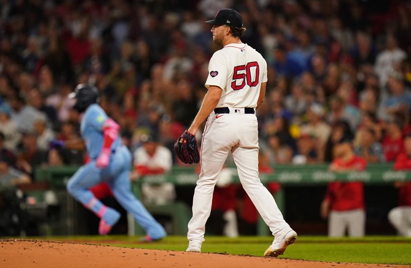 Aug 29, 2024; Boston, Massachusetts, USA; Boston Red Sox starting pitcher Kutter Crawford (50) looks on as Toronto Blue Jays designated hitter Vladimir Guerrero Jr. (27) hits a double to drive in a run in the third inning at Fenway Park. Mandatory Credit: David Butler II-USA TODAY Sports