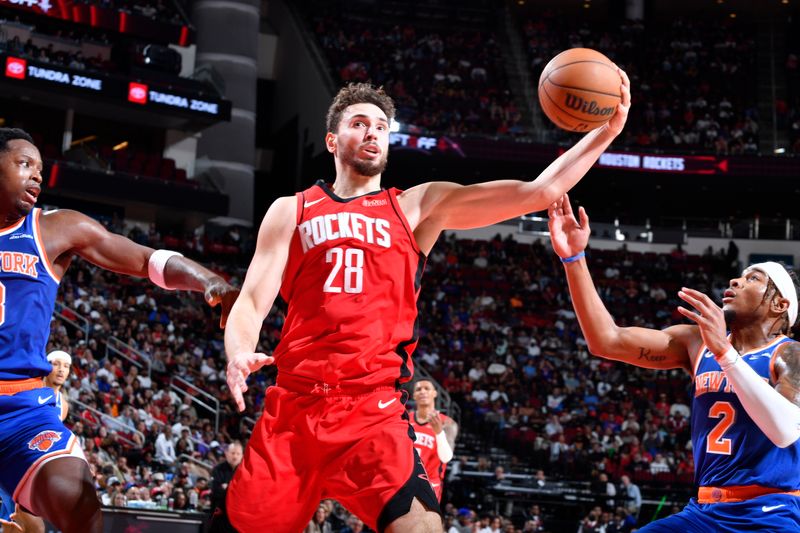 HOUSTON, TX - NOVEMBER 4: Alperen Sengun #28 of the Houston Rockets rebounds the ball during the game against the New York Knicks on November 4, 2024 at the Toyota Center in Houston, Texas. NOTE TO USER: User expressly acknowledges and agrees that, by downloading and or using this photograph, User is consenting to the terms and conditions of the Getty Images License Agreement. Mandatory Copyright Notice: Copyright 2024 NBAE (Photo by Logan Riely/NBAE via Getty Images)