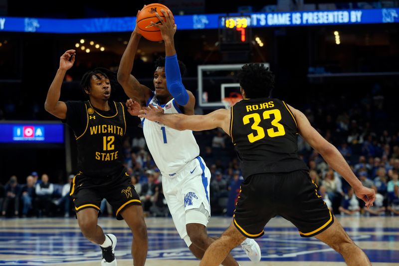 Jan 19, 2023; Memphis, Tennessee, USA; Memphis Tigers guard Keonte Kennedy (1) drives to the basket between Wichita State Shockers guard Melvion Flanagan (12) and forward James Rojas (33) during the second half at FedExForum. Mandatory Credit: Petre Thomas-USA TODAY Sports