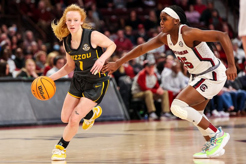 Jan 15, 2023; Columbia, South Carolina, USA; Missouri Tigers guard Lauren Hansen (1) drives past South Carolina Gamecocks guard Raven Johnson (25) in the second half at Colonial Life Arena. Mandatory Credit: Jeff Blake-USA TODAY Sports