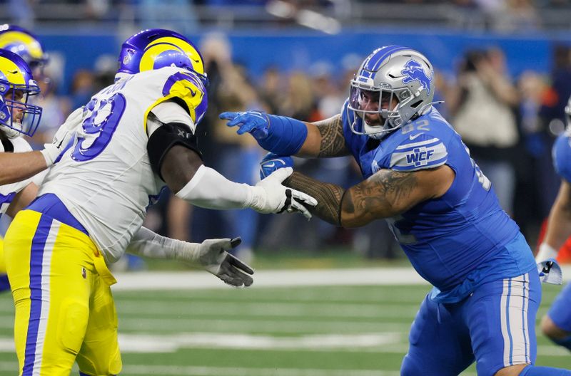 Detroit Lions tight end James Mitchell (82) blocks against Los Angeles Rams guard Kevin Dotson (69)during the first half of an NFL wild-card playoff football game Sunday, Jan. 14, 2024 in Detroit. (AP Photo/Duane Burleson)